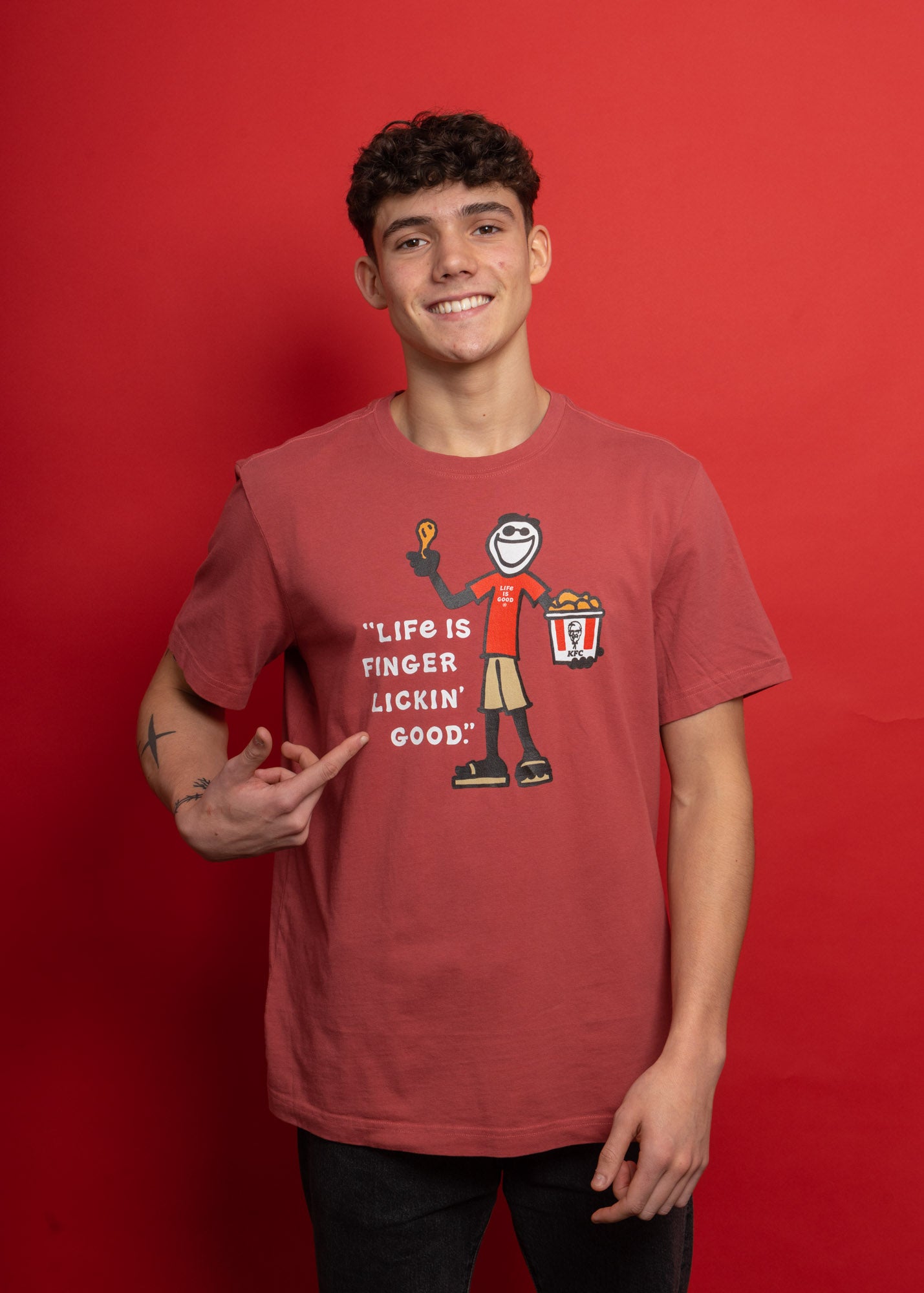 model wearing KFC x Life is Good collaboration red tee shirt