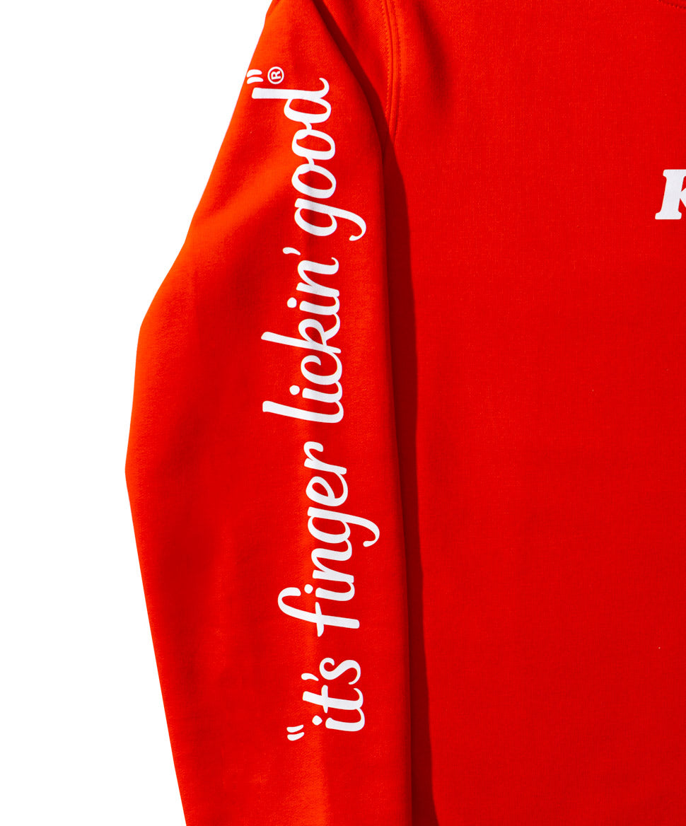 Red junmper with white KFC it's finger lickin good down the sleeve