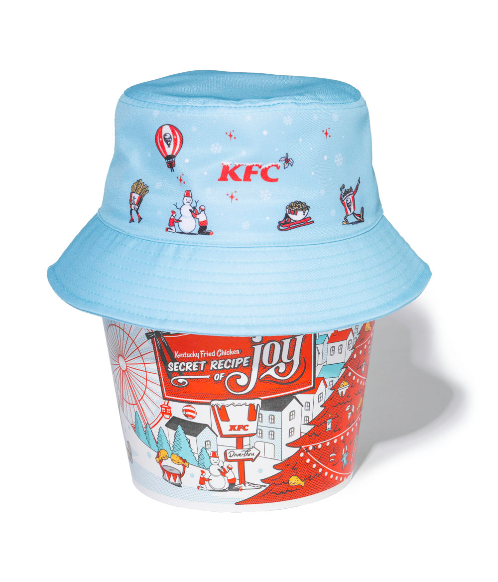 festive teal KFC christmas bucket hat on top of a KFC bucket