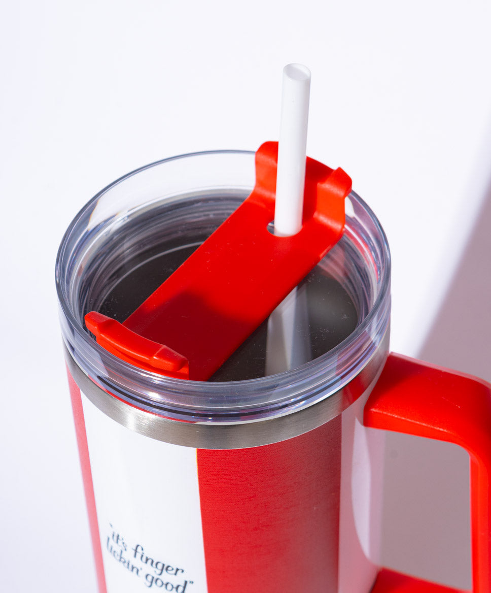 close up red and white striped KFC tumbler with straw