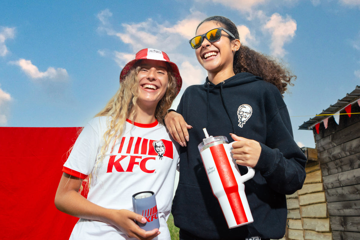 models wearing KFC hoodie, t shirt and bucket merch holding a KFC tumbler